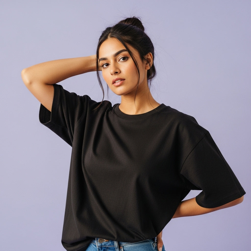 Woman wearing a black oversized t-shirt against a light purple background